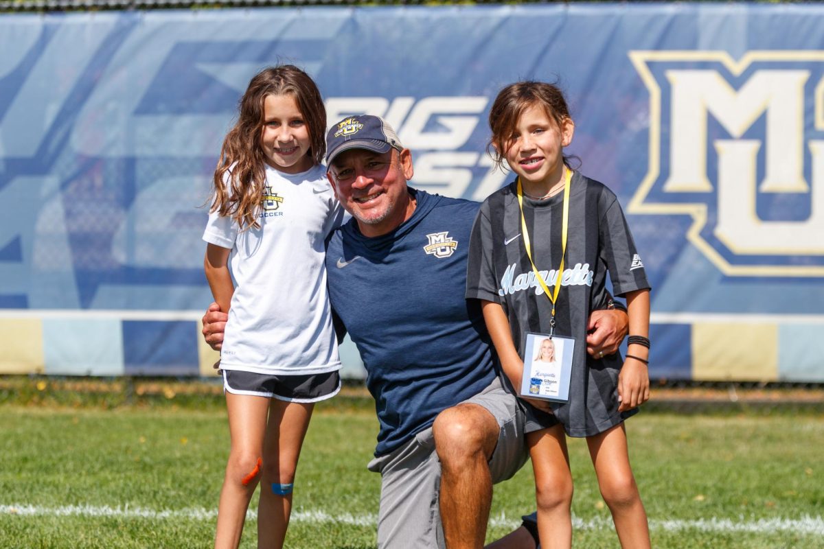 Head coach, Frank Pelaez with Team Impact participants, Chloe and Kendall. (Photo courtesy of Marquette Athletics)