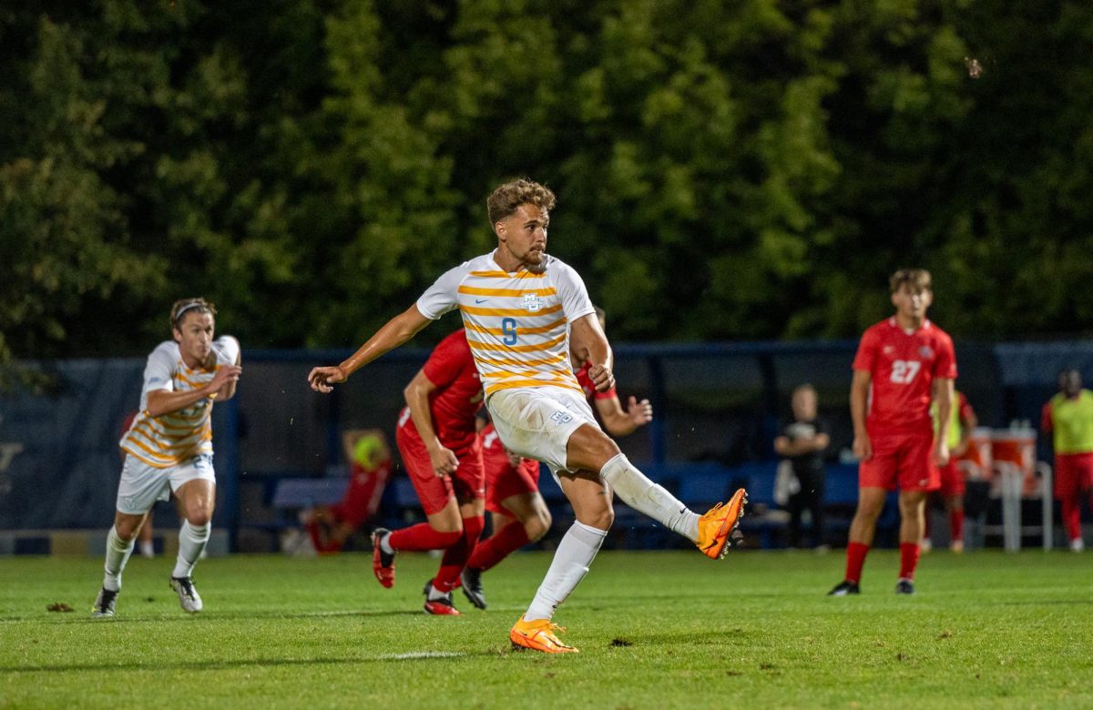 Senior forward Noah Madrigal scores a penalty in Marquette mens soccers 6-0 win over Detroit Mercy.
