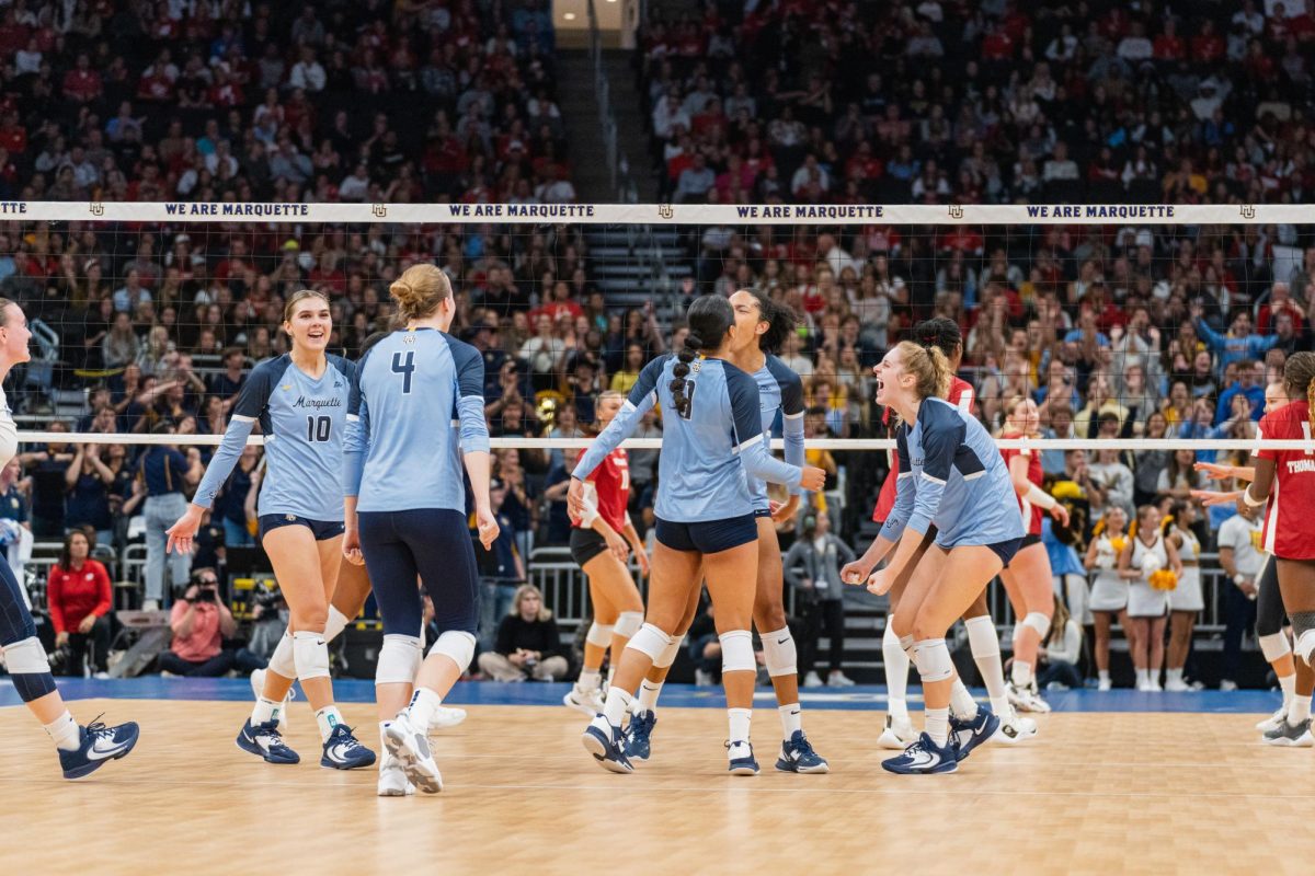 The volleyball team celebrates a point in its 3-1 loss to Wisconsin in Fiserv Forum.
