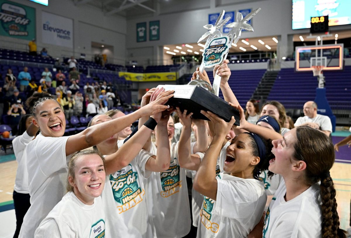 Marquette womens basketball holding the Fort Myers Tip-Off championship trophy after beating Arkansas 74-58. (Photo courtesy of Marquette Athletics.)