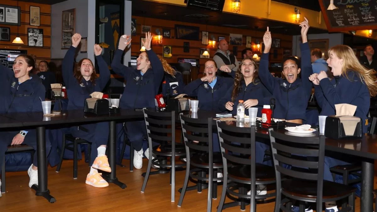 Marquette volleyball celebrates its name being called as the No. 6 seed during a watch-party in the Union Sports Annex. (Photo courtesy of Marquette Athletics.)