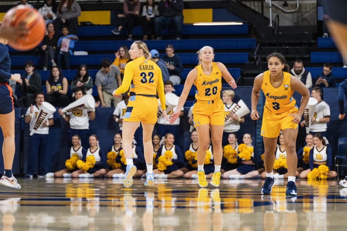 Frannie Hottinger (20) and Liza Karlen (32) started playing basketball together in high school for the same AAU Team. Now, the two are back together at Marquette.