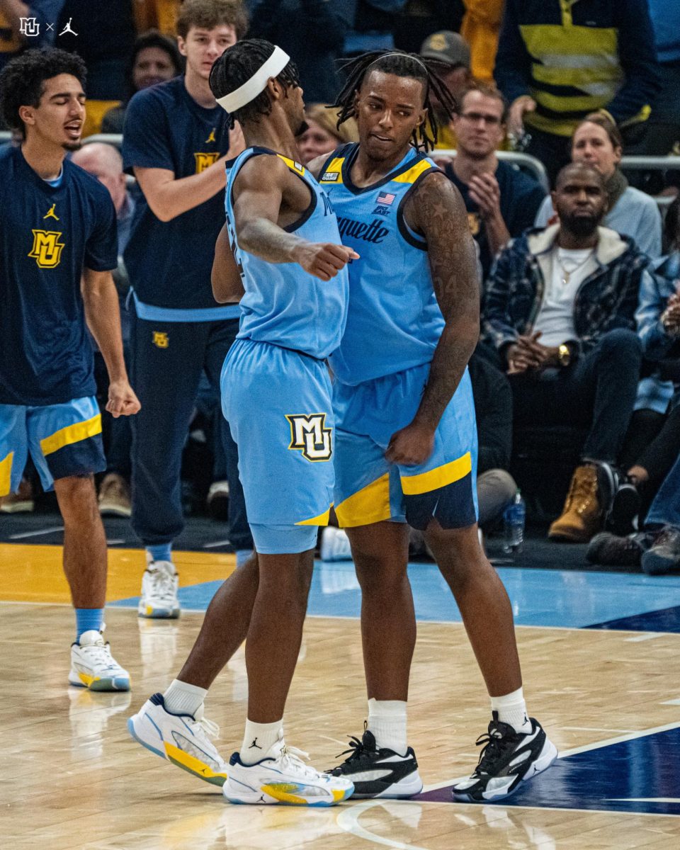 Guards Chase Ross and Tre Norman give each other a chest-bump in No. 6 Marquettes 81-51 win over Georgetown. (Photo courtesy of Marquette Athletics.)