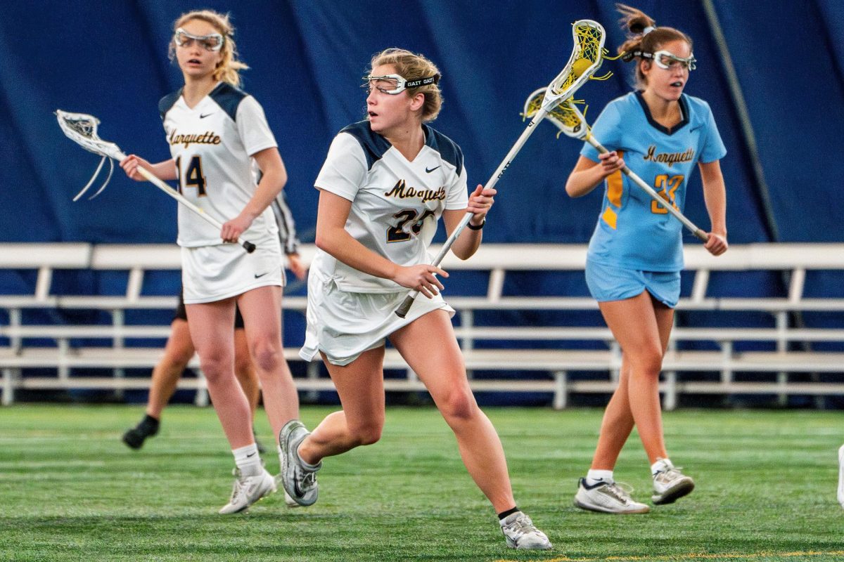 Eileen Dooley (left) and Maeve Dooley (center) in a pre-season scrimmage. (Photo courtesy of Marquette Athletics.)