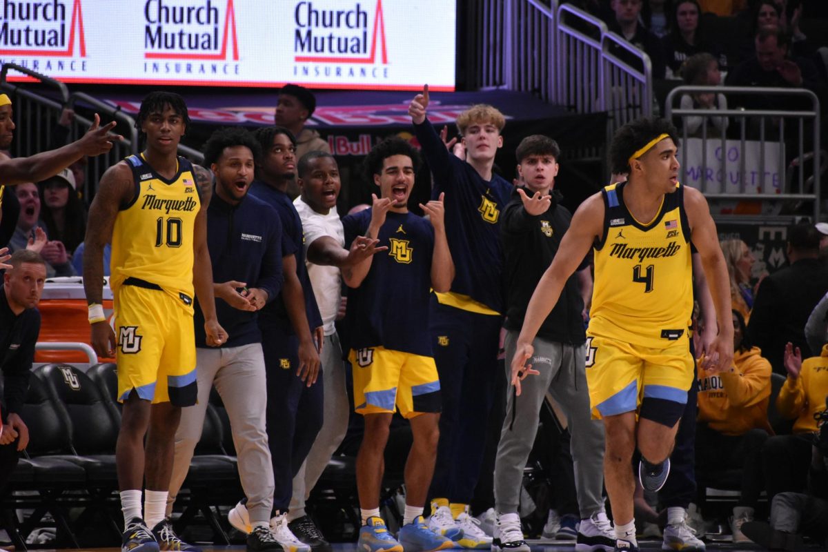 Marquettes bench celebrates in its 86-75 National Marquette Day win over St. Johns.