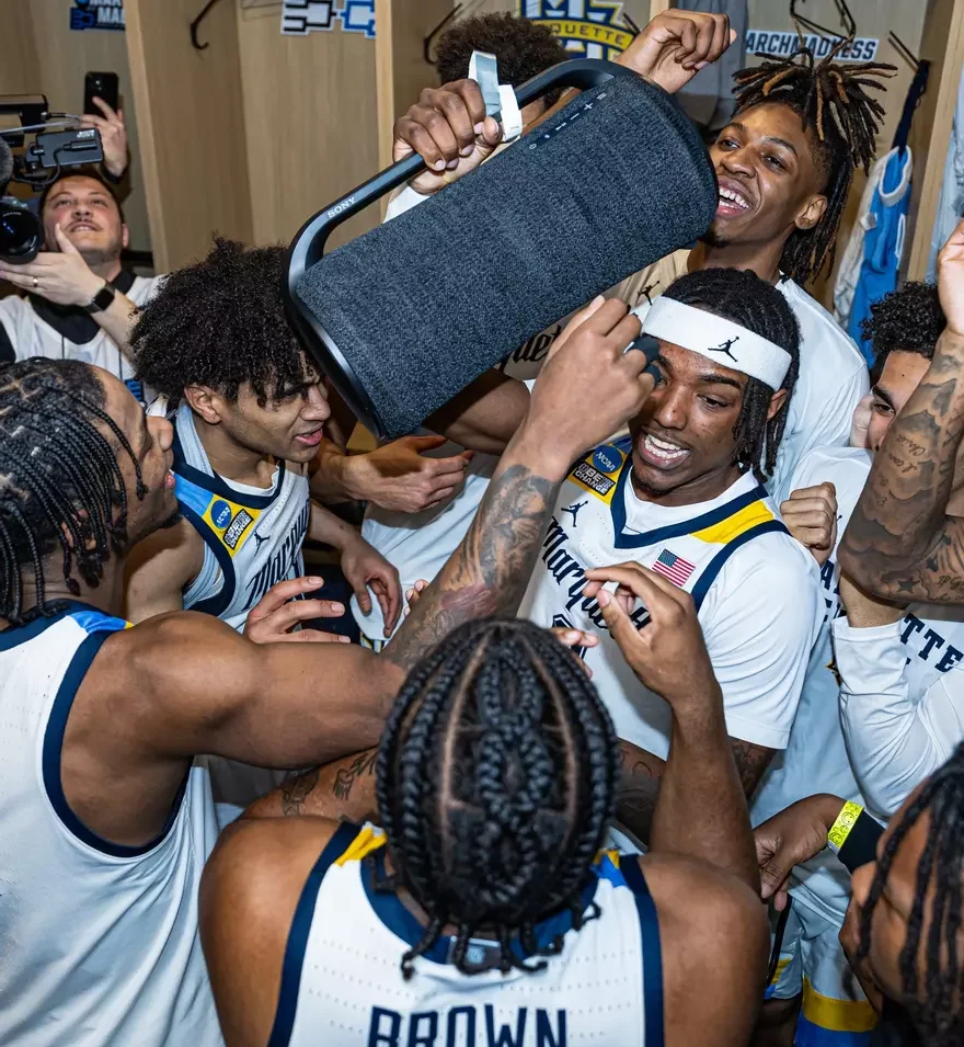 Marquette+mens+basketball+celebrates+in+the+locker+room+with+a+speaker+after+its+win+over+Colorado.+%28Photo+courtesy+of+Marquette+Athletics.%29