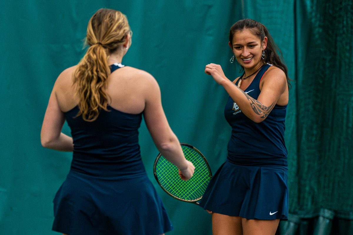 Tiana Windbuchler (right) and Emma Davis (left) have played together as doubles partners this season. (Photo courtesy of Marquette Athletics.)