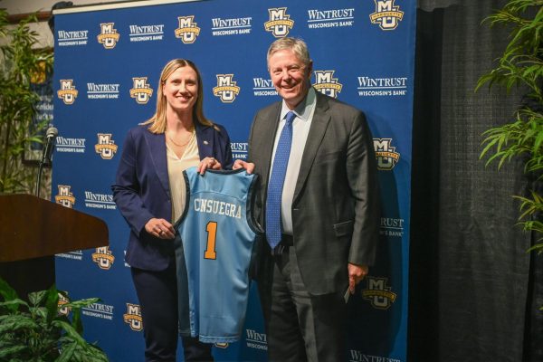 Navigation to Story: Former players and coaches come back to Marquette to support new head coach Cara Consuegra