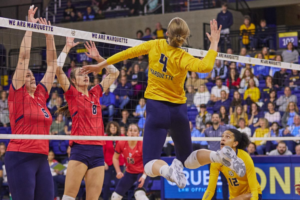 Jenna Reitmsa (4) and Carsen Murray (12) are excited for Marquette volleyball's season. (Photo courtesy of Marquette Athletics.)