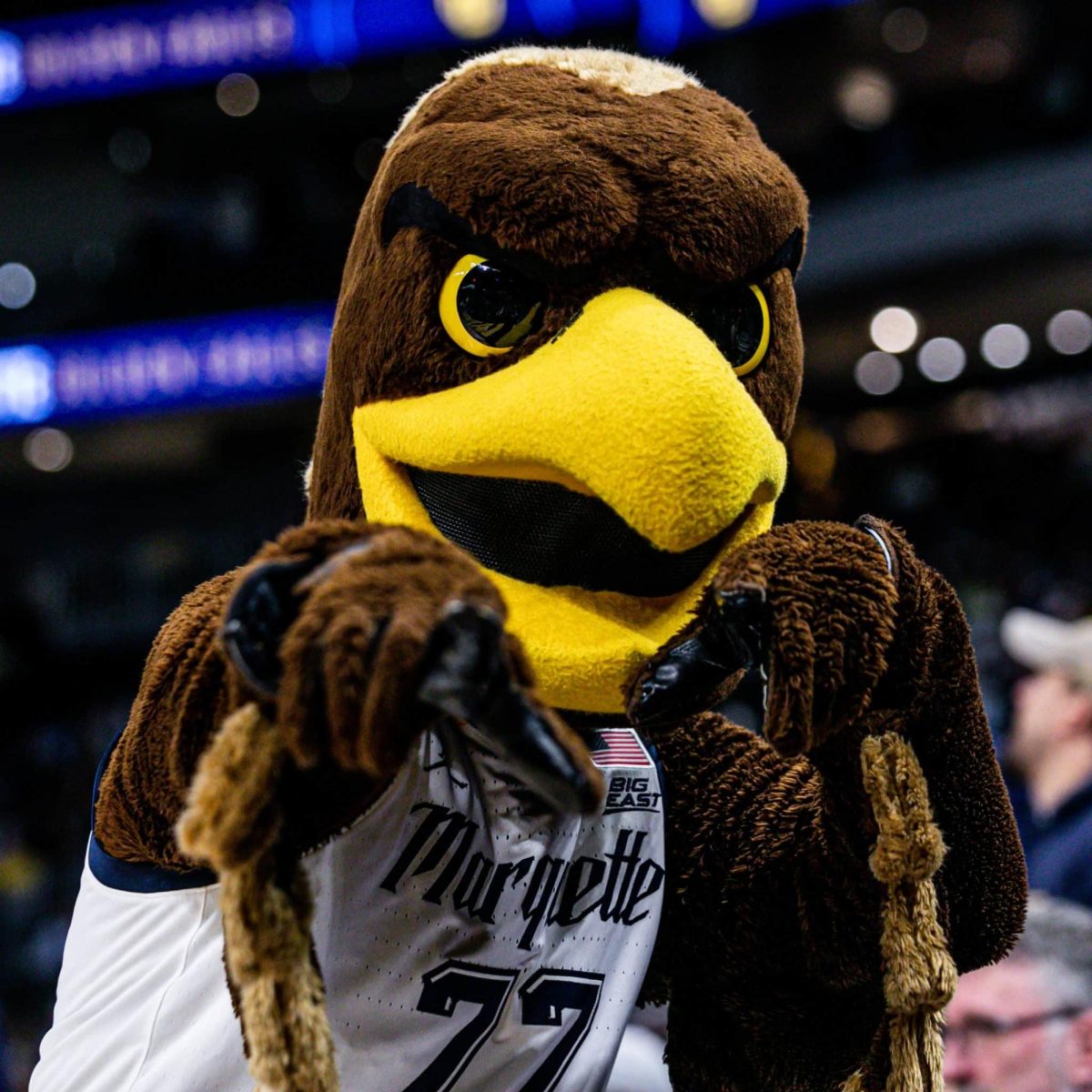 Marquette Mascot, Iggy, at Marquette Men's Basketball game hyping up the crowd. (Photo courtesy of Mascot Hall of Fame.)