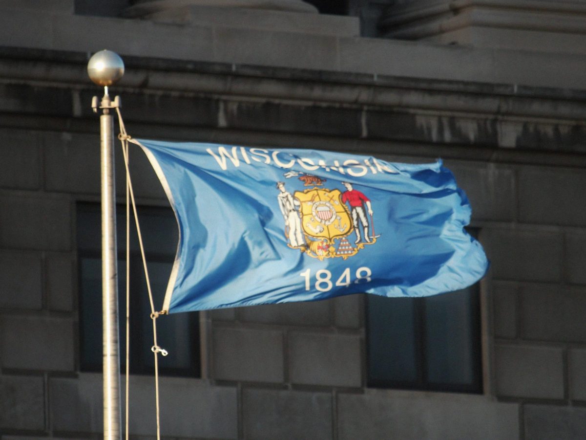 Wisconsin's current state flag is the state seal over a blue background with text.