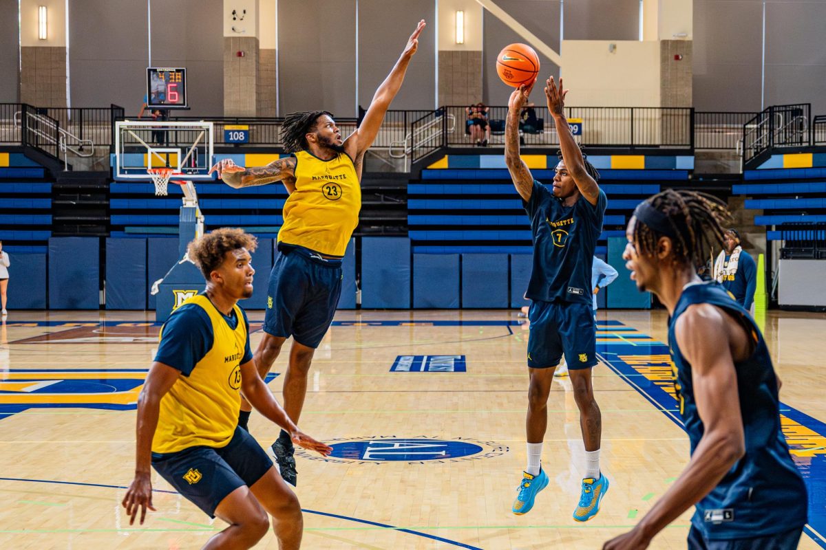 Zaide Lowery (right) shoots a three-pointer in Marquette Blue & Gold scrimmage. (Photo courtesy of Marquette Athletics.)