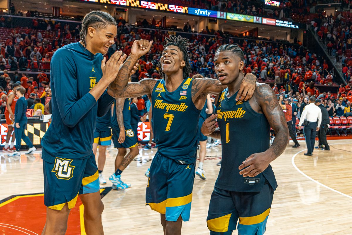 Kam Jones (Right), Zaide Lowery (Center) and Josh Clark (Left) celebrate after Marquette's 78-74 win over Maryland on Friday, Nov. 15. (Photo courtesy of Marquette Athletics.)
