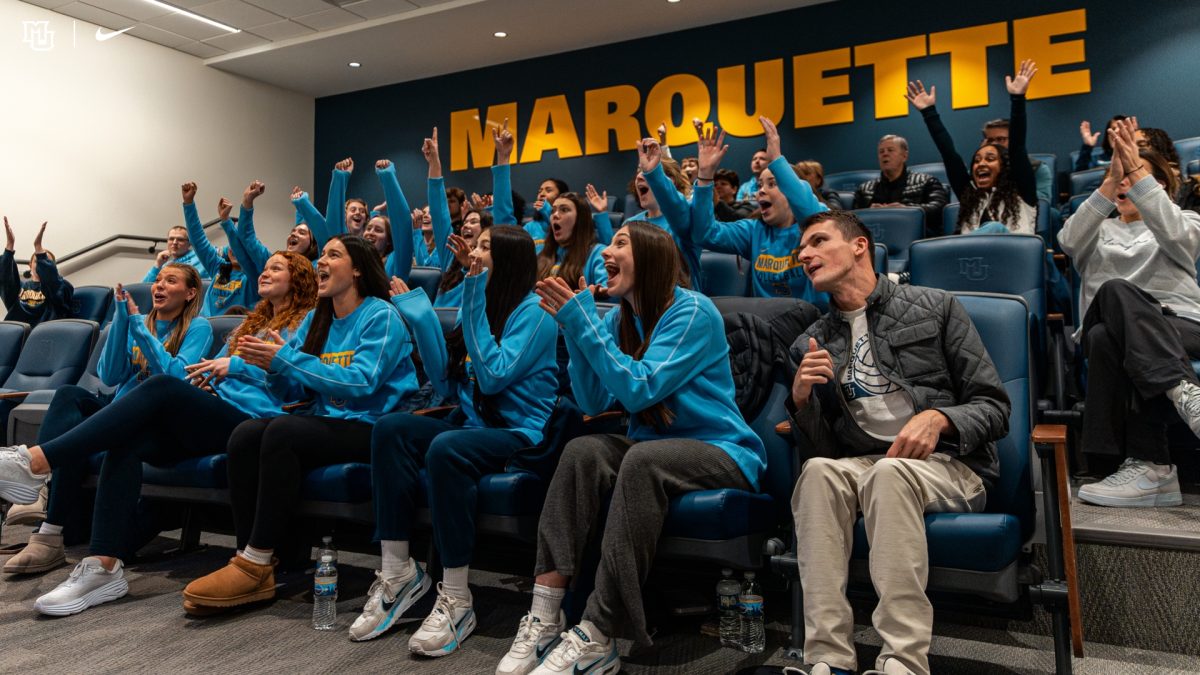 Marquette volleyball players celebrate as they hear their name called as a No. 5 seed. (Photo courtesy of Marquette Athletics.) 