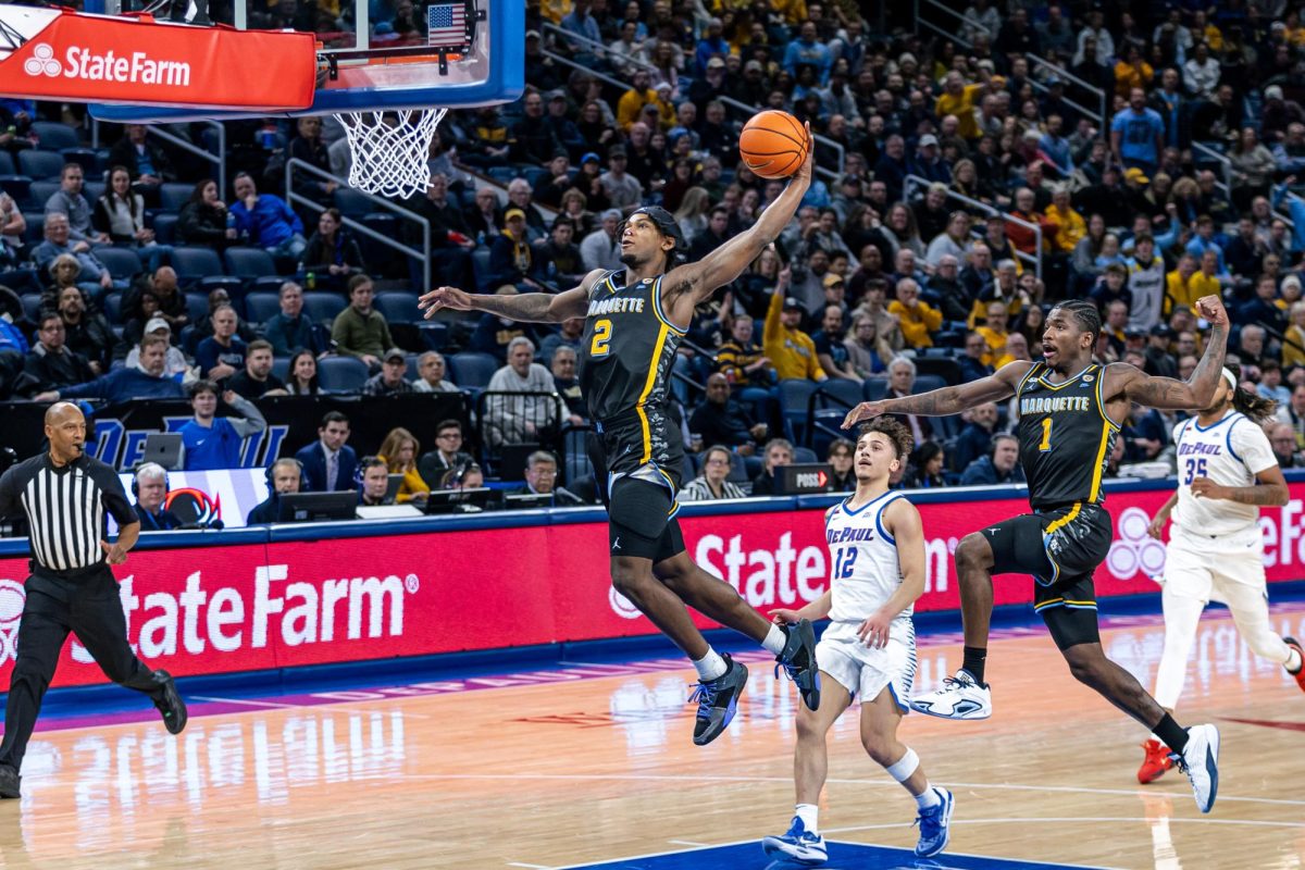 Chase Ross (2) throws down a fast break dunk during Marquette's 85-83 win at Wintrust Arena on Tuesday, Jan. 14.