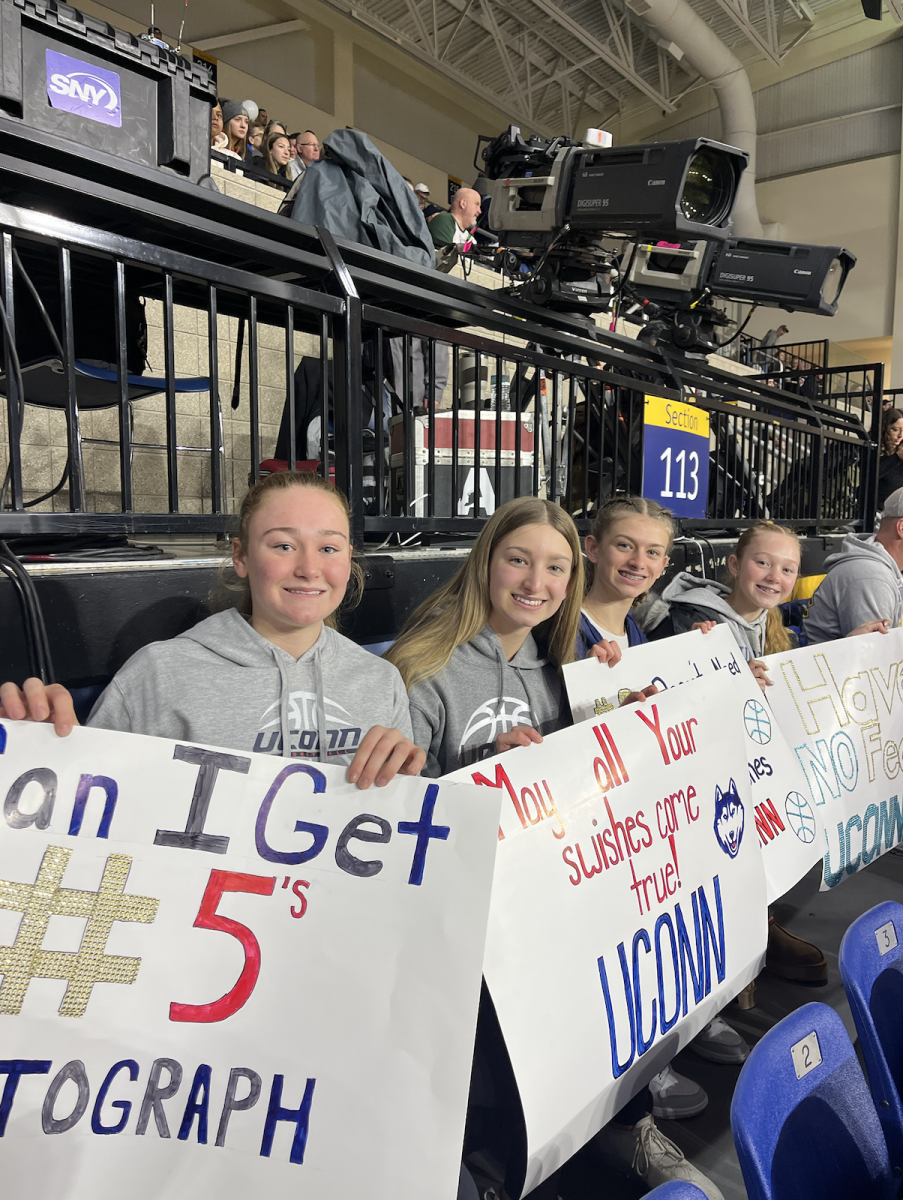 Lauren Jungwirth (right), Allison Steinbrecher, Isabelle Steinbrecher and Harley Jungwirth (left) holding their homemade signs. 