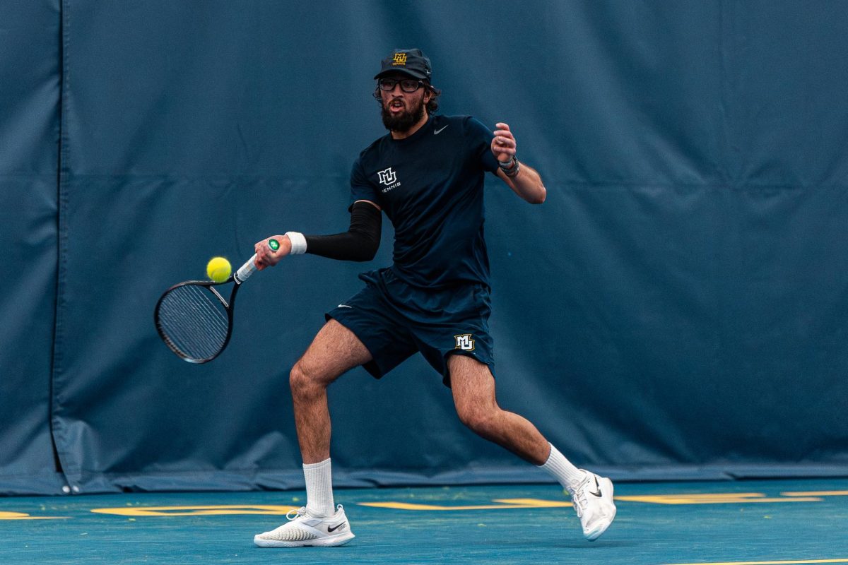 First-year Cyrus Ahmad earned his fourth win in singles play to give Marquette its second point in its 4-3 loss to North Dakota on Feb. 21. (Photo courtesy of Marquette Athletics.)