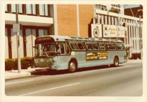 A 1975 bus stops in front of the former Holiday Inn Central, now Mashuda Hall. Photo courtesy of MCTS media library.