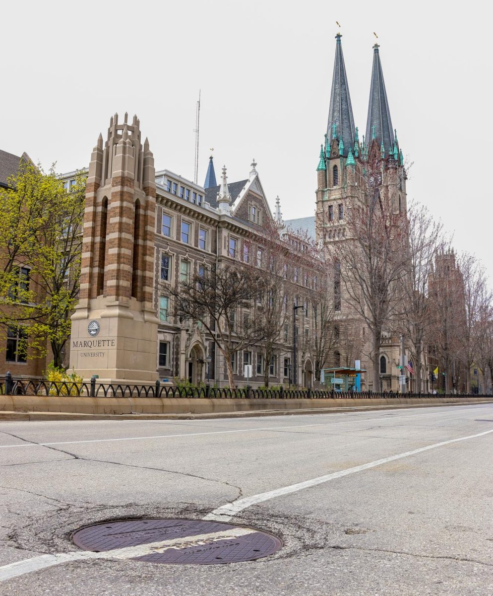 Manhole covers are a window into the labyrinth of pipes and mains that run underneath Marquette and Milwaukee.