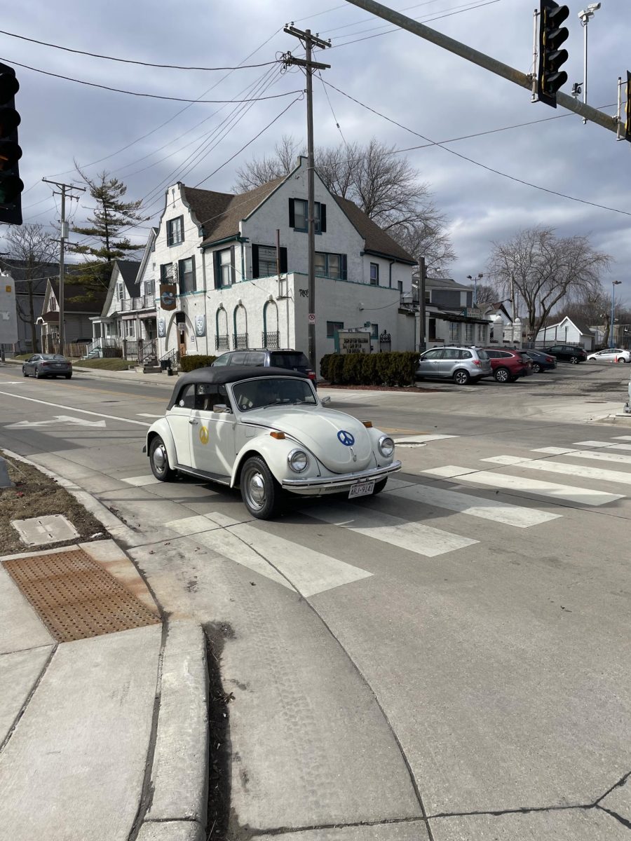 A classic bug cruises on Locust Street through Riverwest.