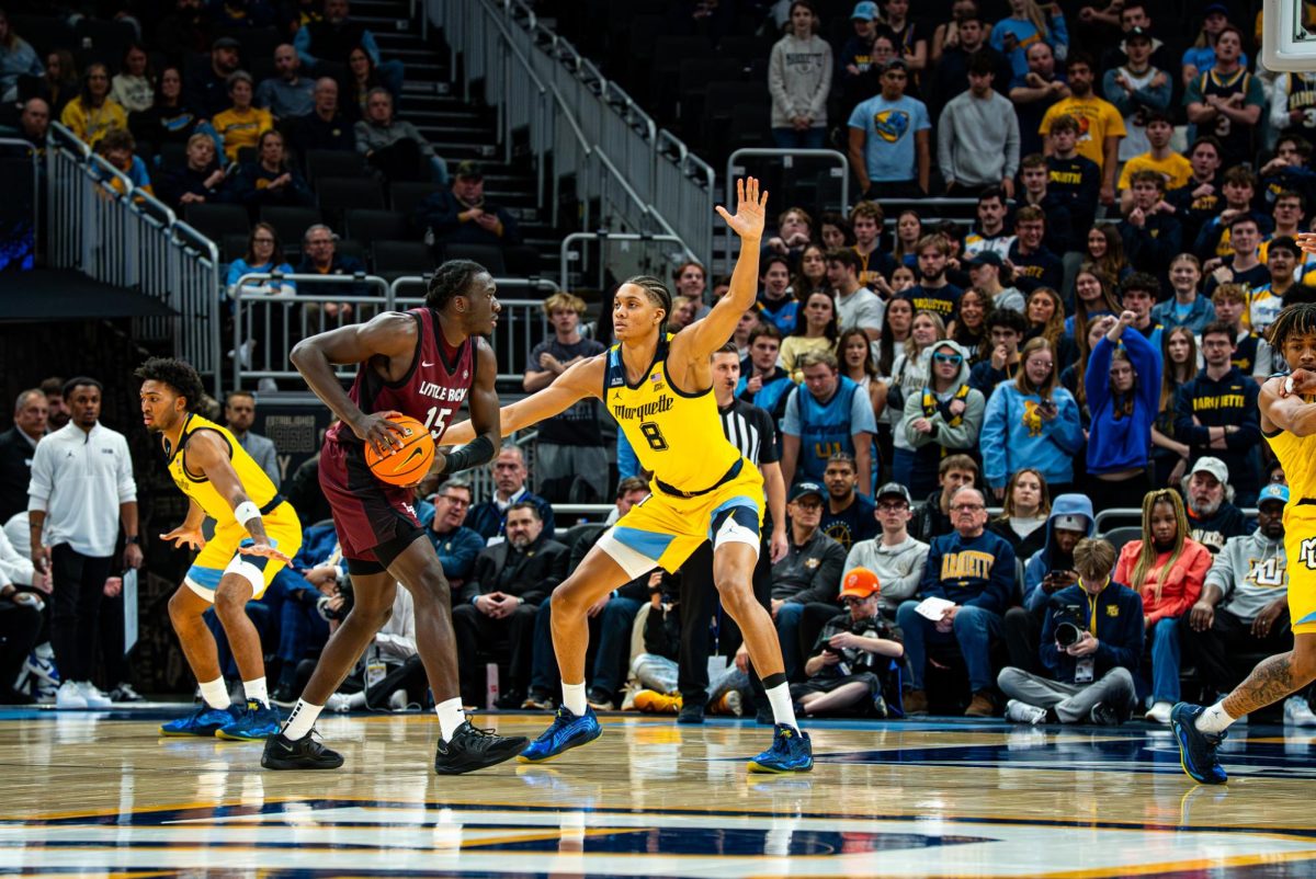 Josh Clark (8) defends Kachi Nzeh (15) during Marquette's 89-49 victory over Little Rock on Nov. 12.