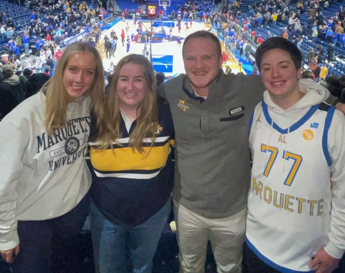 Sam Gutierrez (right) started making his own Marquette jerseys while a student at the university in 2021.