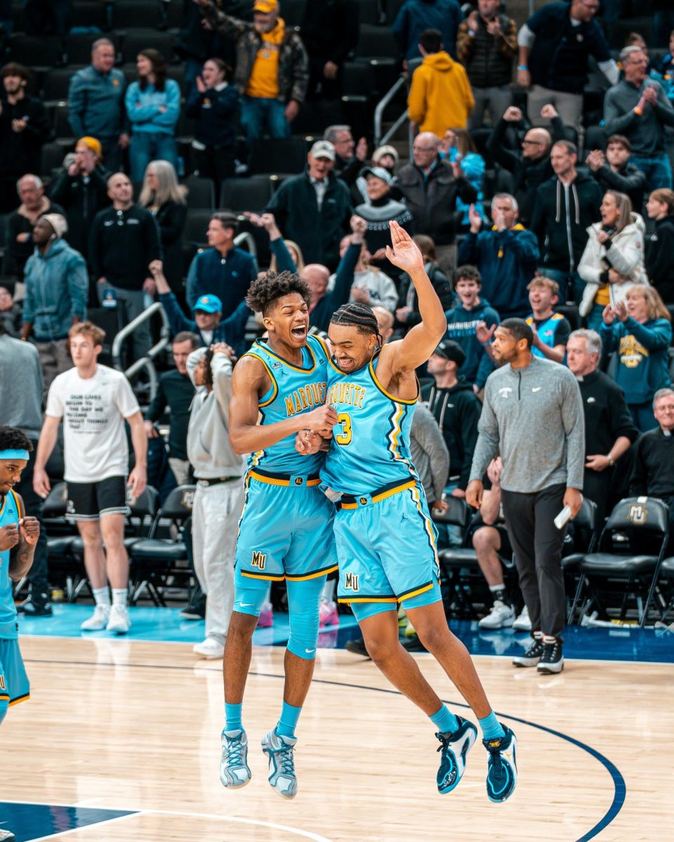 Damarius Owens (left) and Royce Parham (right) celebrate during Marquette's 105-104 overtime win against Providence on Jan. 19.