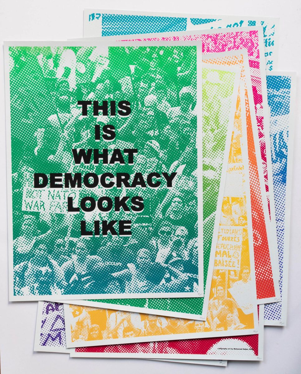 "THIS IS WHAT DEMOCRACY LOOKS LIKE" is one of the many screen-printed art pieces in the exhibit. (Photo courtesy of Aaron Hughes)